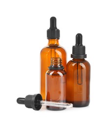 Photo of Glass bottles and pipette with tincture isolated on white