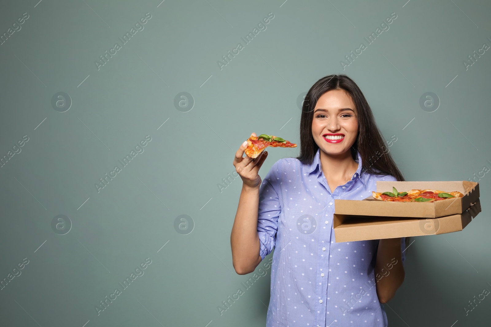 Photo of Attractive young woman with delicious pizza on color background