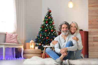 Happy mature couple celebrating Christmas at home