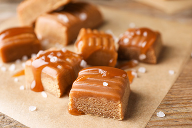 Photo of Salted caramel on wooden table, closeup view