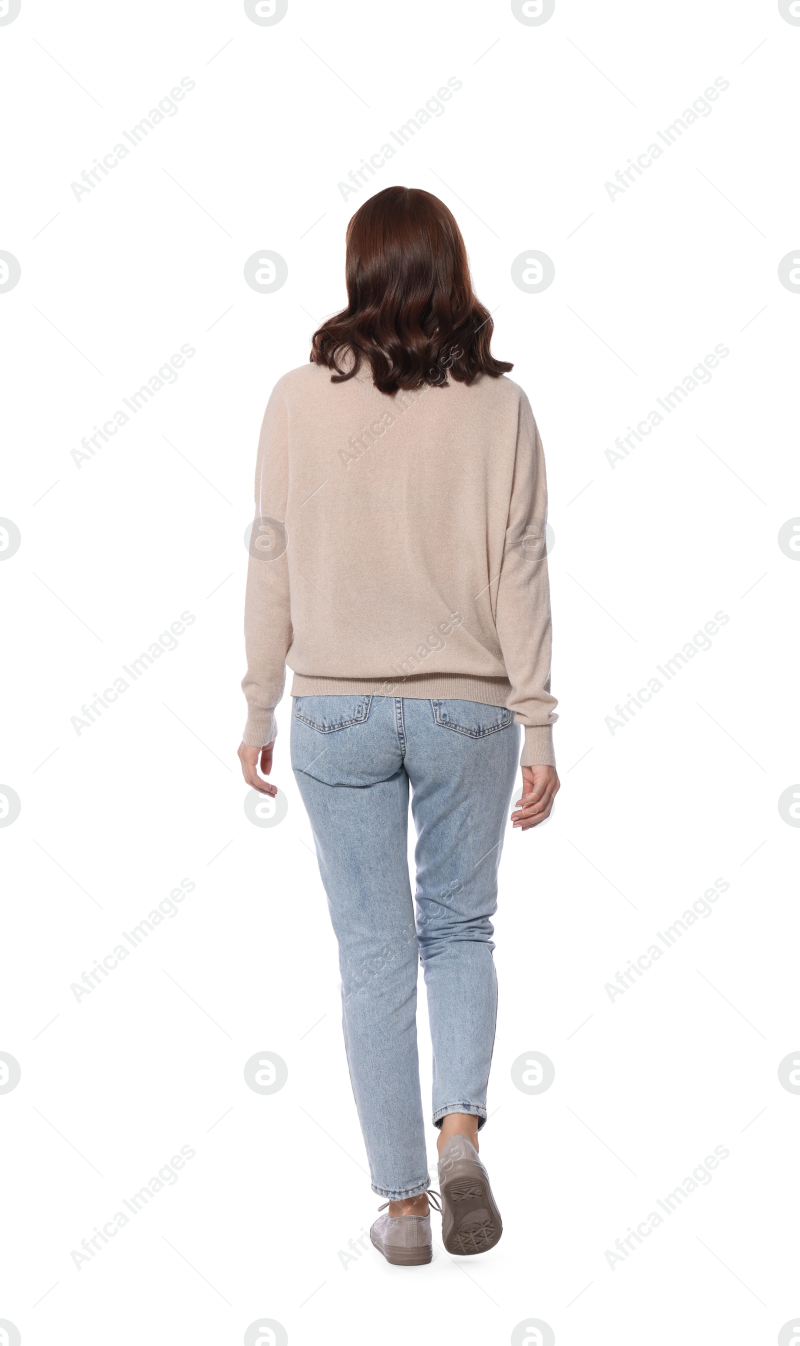 Photo of Woman in casual outfit walking on white background, back view