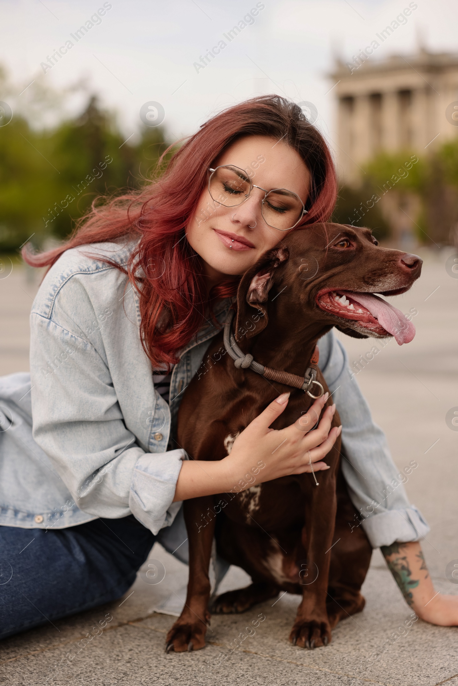 Photo of Woman with her cute German Shorthaired Pointer dog outdoors