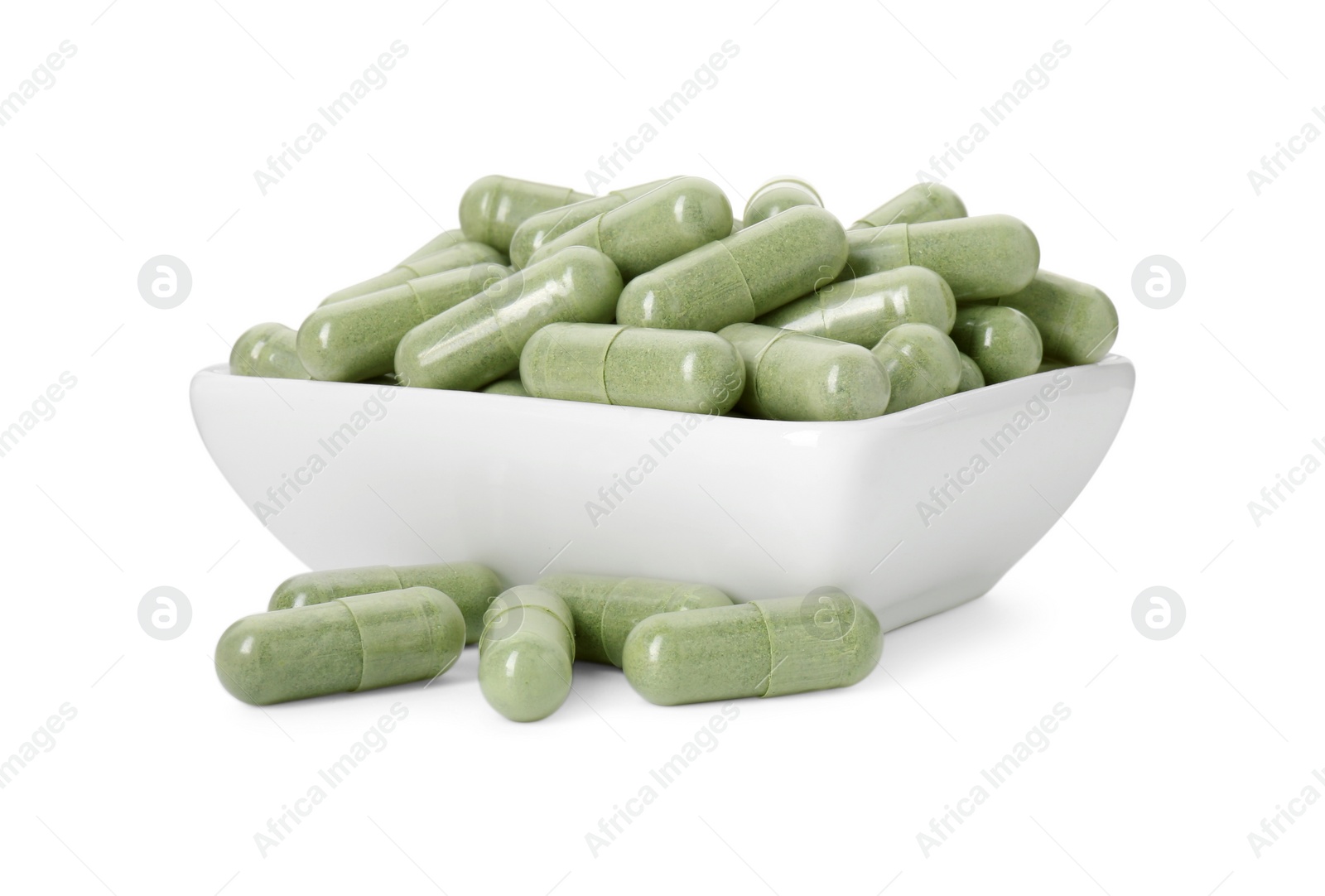 Photo of Vitamin capsules in bowl isolated on white. Health supplement