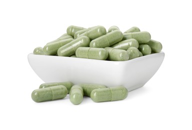 Photo of Vitamin capsules in bowl isolated on white. Health supplement