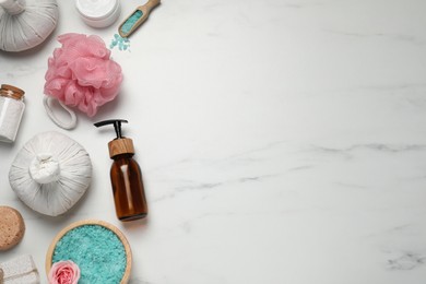 Flat lay composition of herbal bags and spa products on white marble table. Space for text