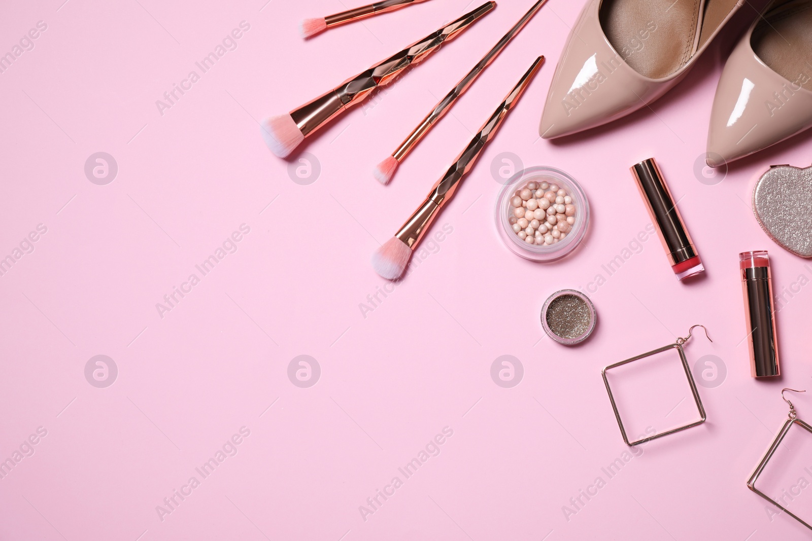 Photo of Makeup products, earrings and women's accessories on pink background, flat lay. Space for text