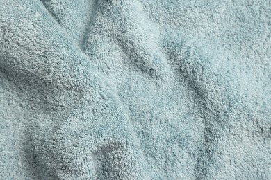 Photo of Soft crumpled light blue towel as background, top view