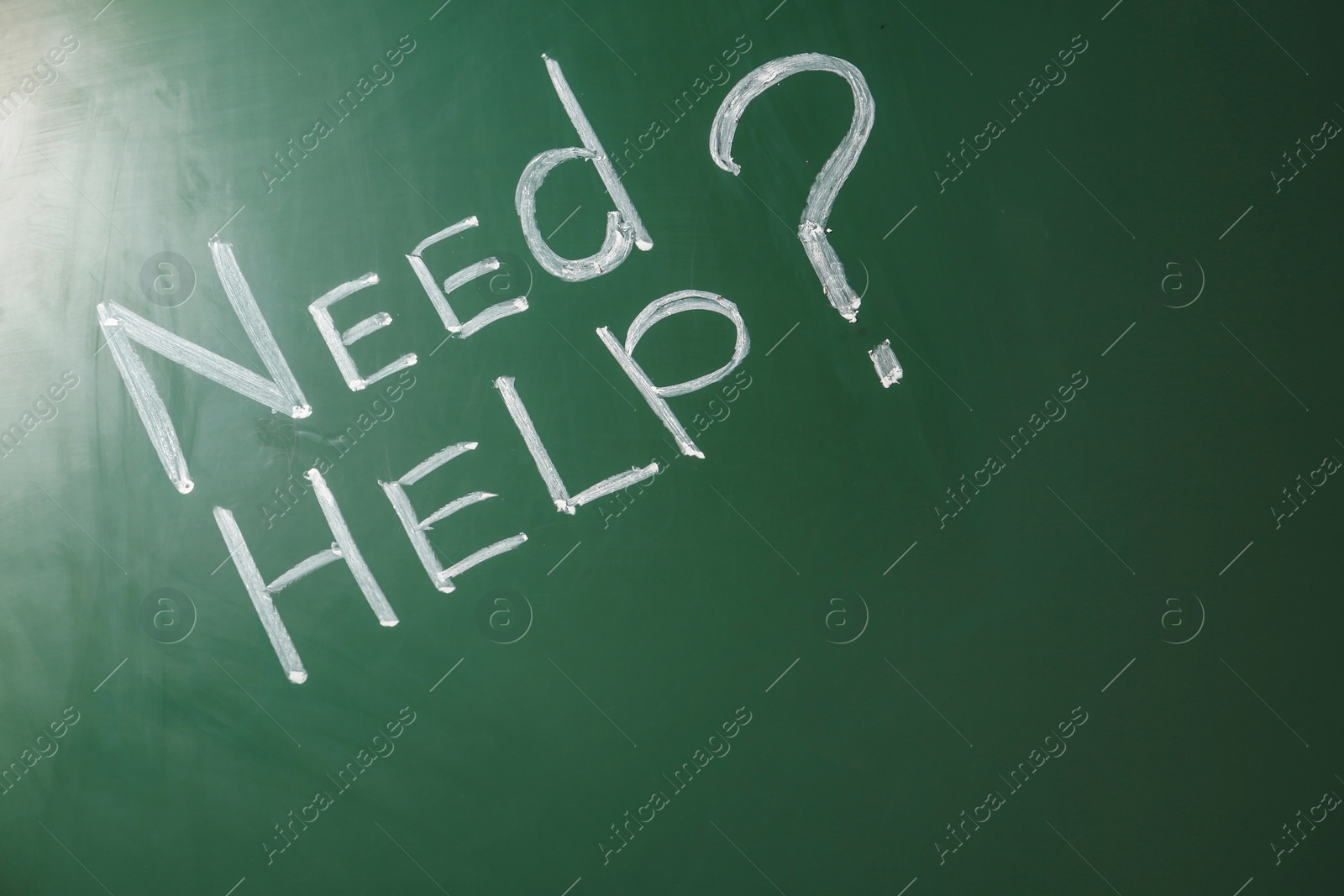 Photo of Phrase "Need help?" written on green chalkboard. Space for text