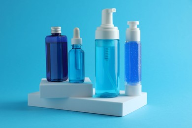 Set of luxury cosmetic products on light blue background