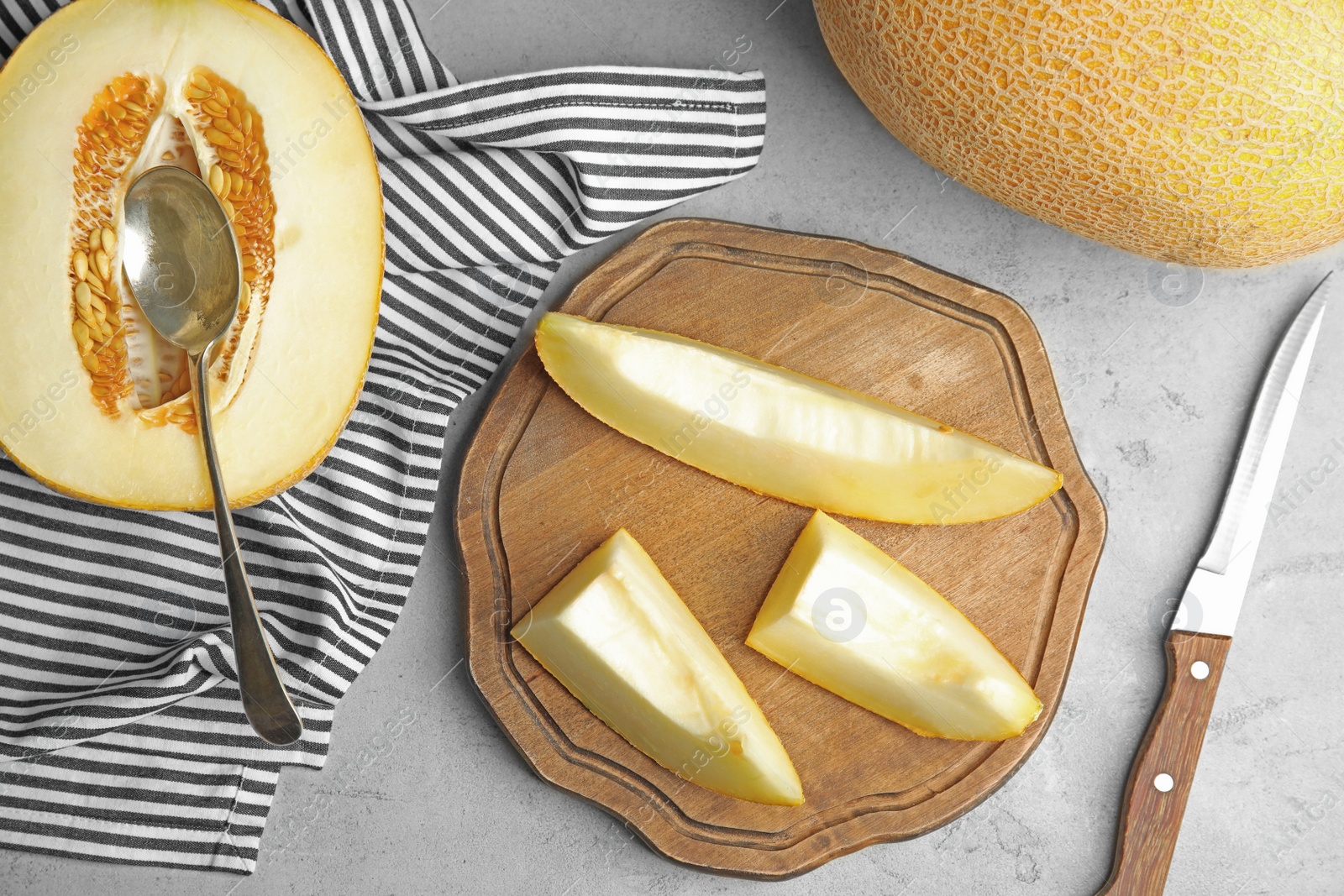 Photo of Flat lay composition with ripe melons on grey table