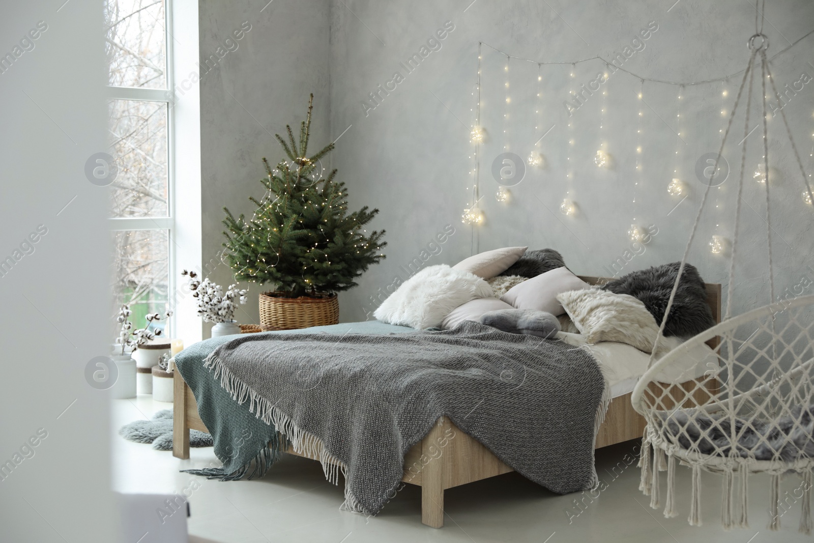 Photo of Elegant bedroom interior with little decorated Christmas tree