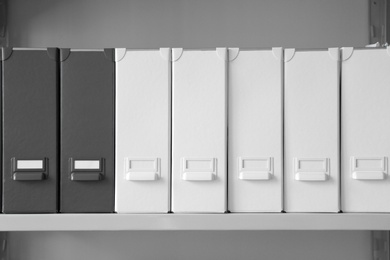 Photo of Folders with documents on shelf in archive