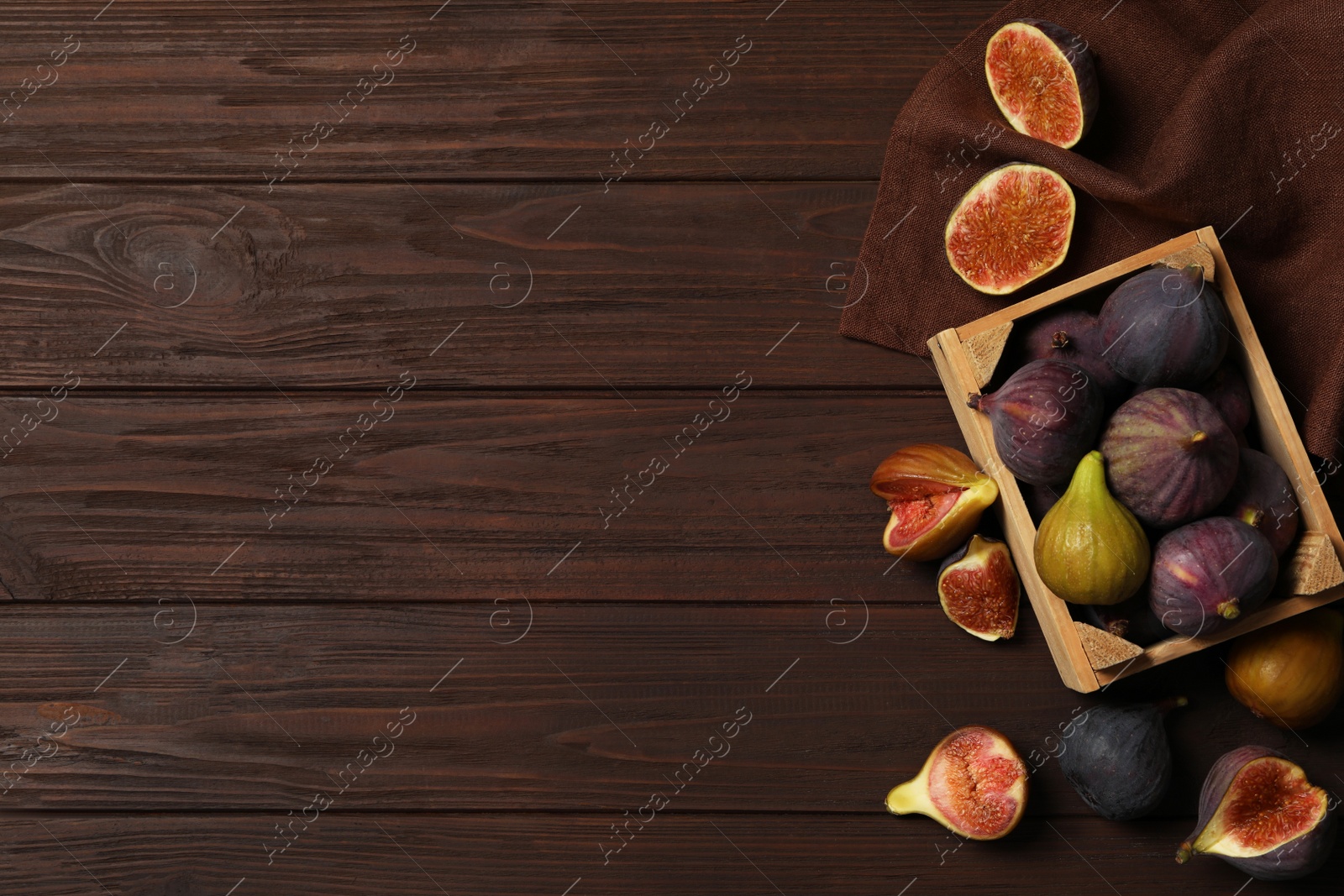 Photo of Tasty raw figs on wooden table, flat lay. Space for text