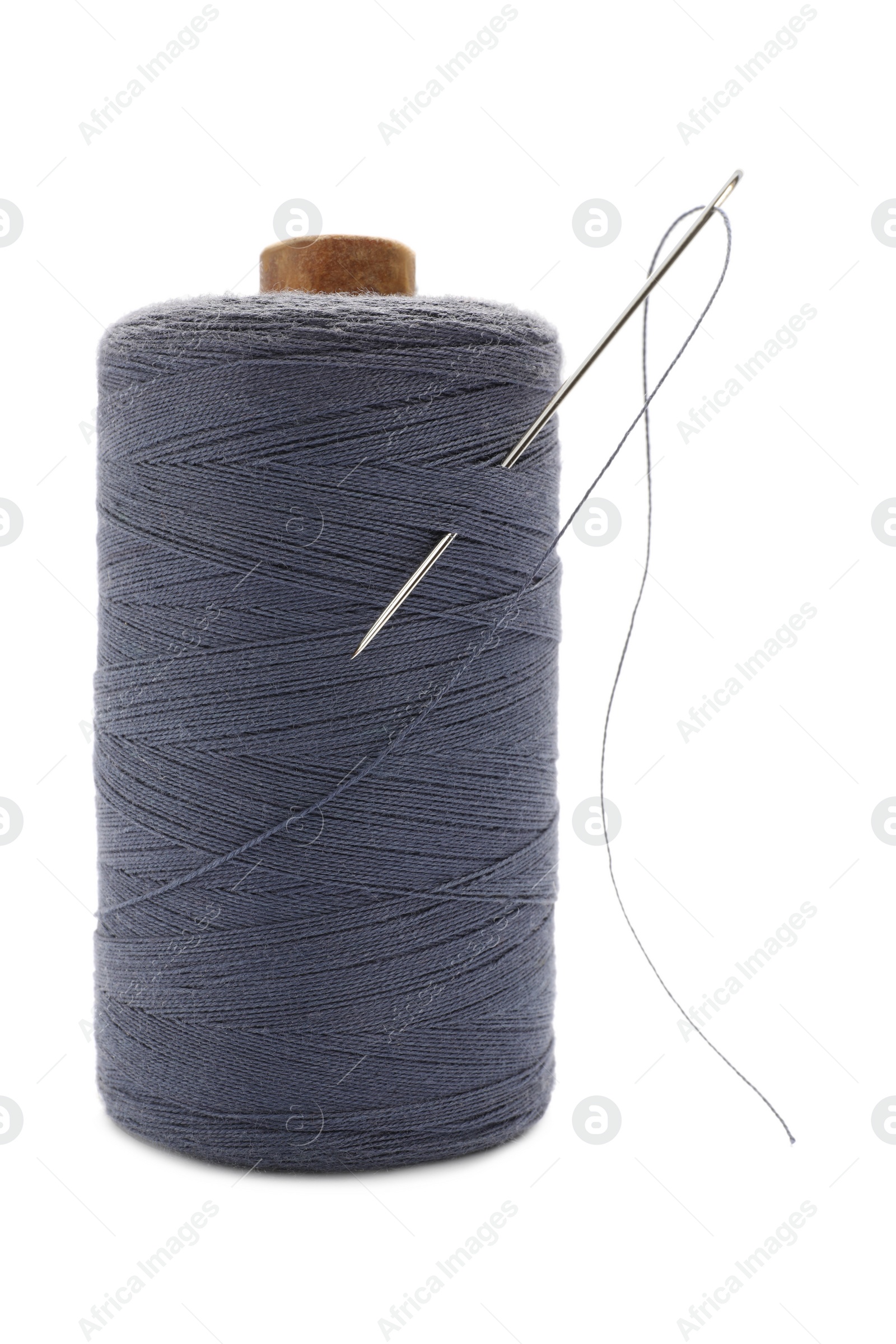 Photo of Grey sewing thread with needle on white background