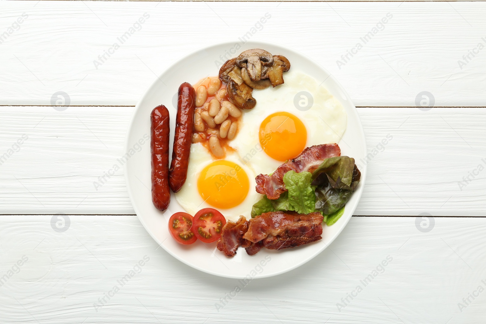Photo of Delicious breakfast with sunny side up eggs on white wooden table, top view