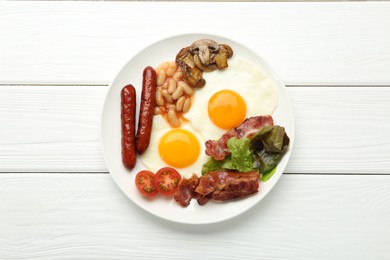 Delicious breakfast with sunny side up eggs on white wooden table, top view