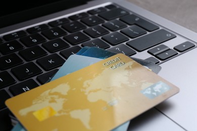 Photo of Laptop with credit cards on table, closeup