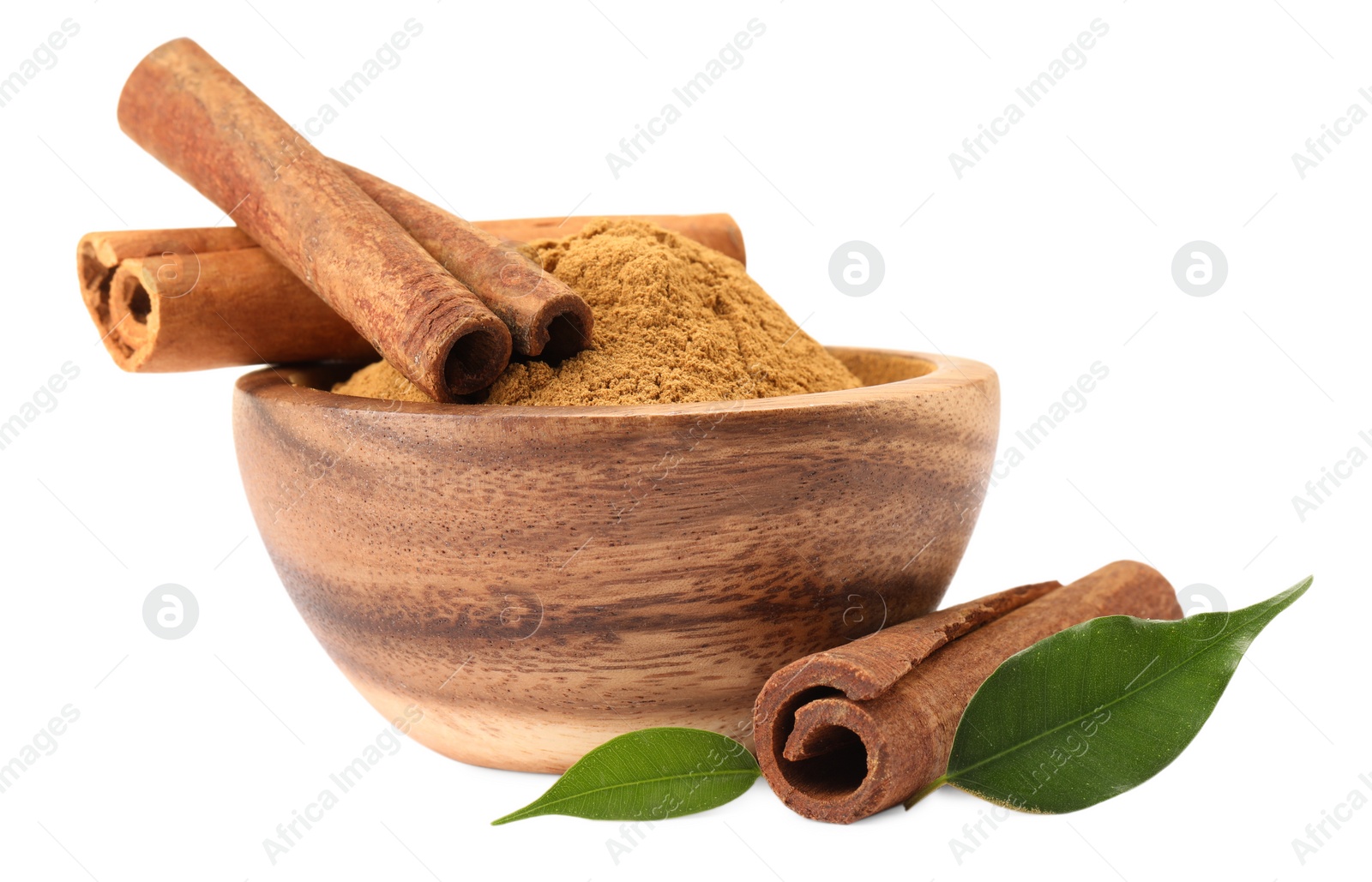 Photo of Dry aromatic cinnamon sticks, powder and green leaves isolated on white