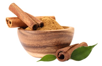 Photo of Dry aromatic cinnamon sticks, powder and green leaves isolated on white