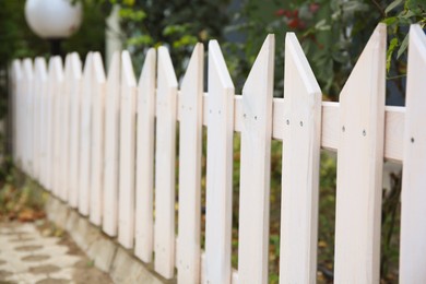 Closeup view of small wooden fence outdoors, space for text