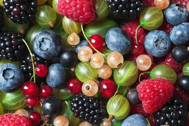 Photo of Raspberries and mix of different berries as background