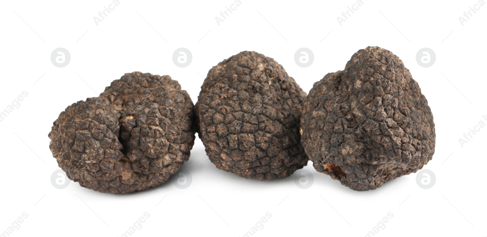 Photo of Fresh whole black truffles isolated on white