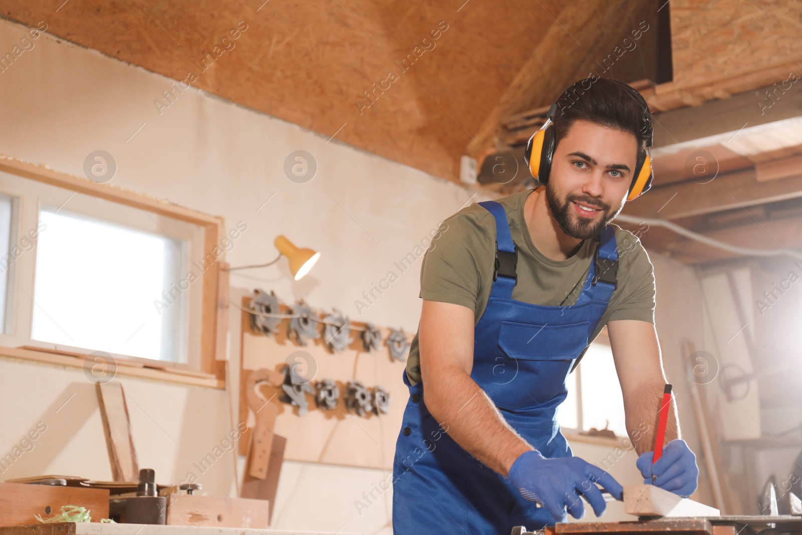 Photo of Professional carpenter working with wood in shop