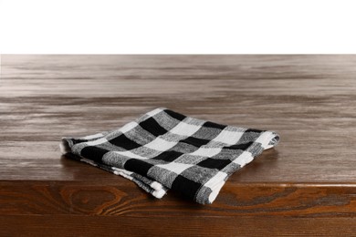 Photo of Checkered tablecloth on wooden table against white background