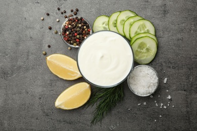 Photo of Flat lay composition with cucumber sauce and ingredients on grey background