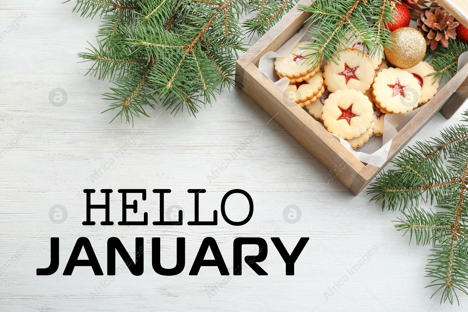 Image of Hello January greeting card. Linzer cookies with sweet jam and fir tree branches on wooden table, flat lay