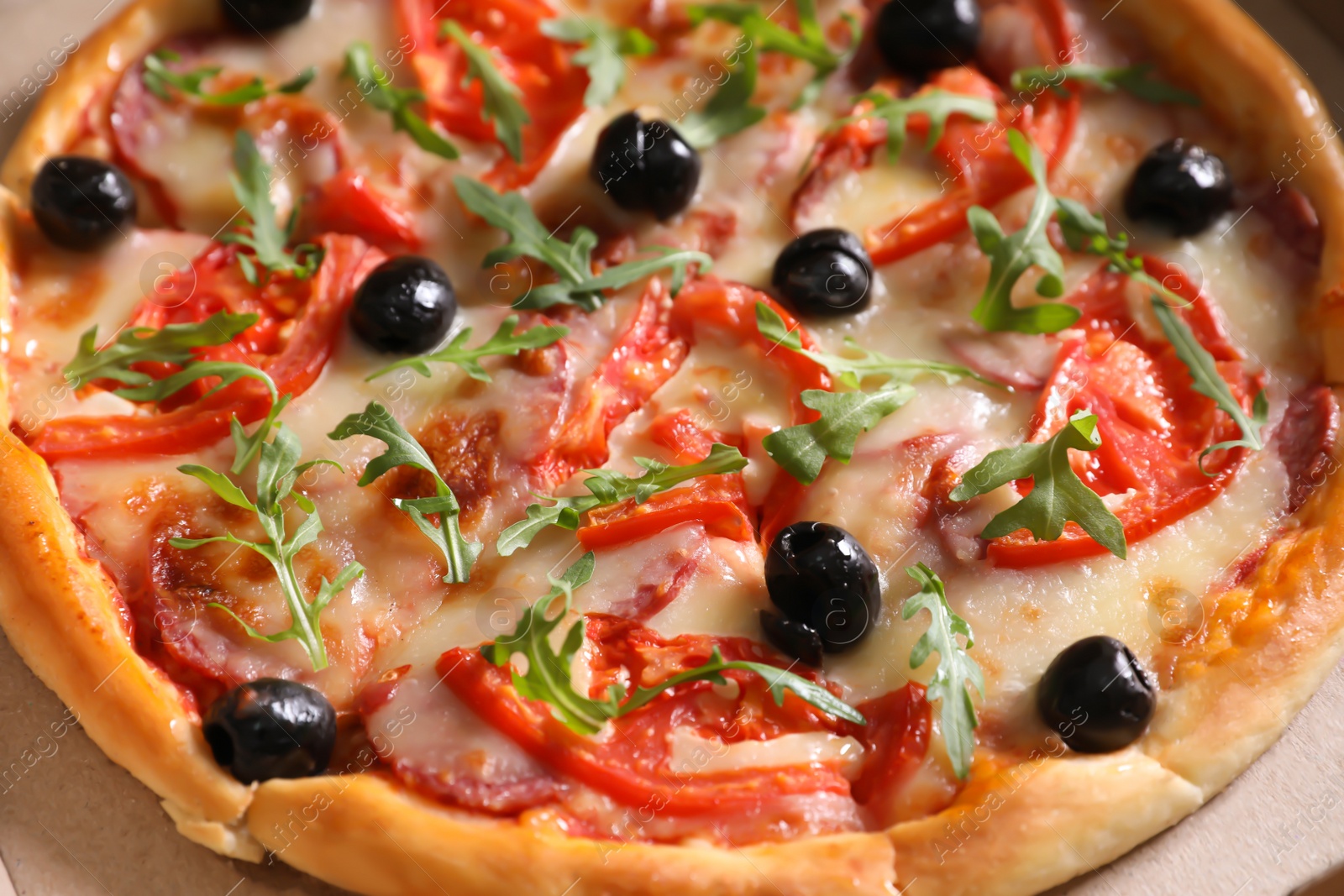 Photo of Tasty fresh pizza with olives in cardboard box, closeup