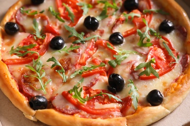 Tasty fresh pizza with olives in cardboard box, closeup