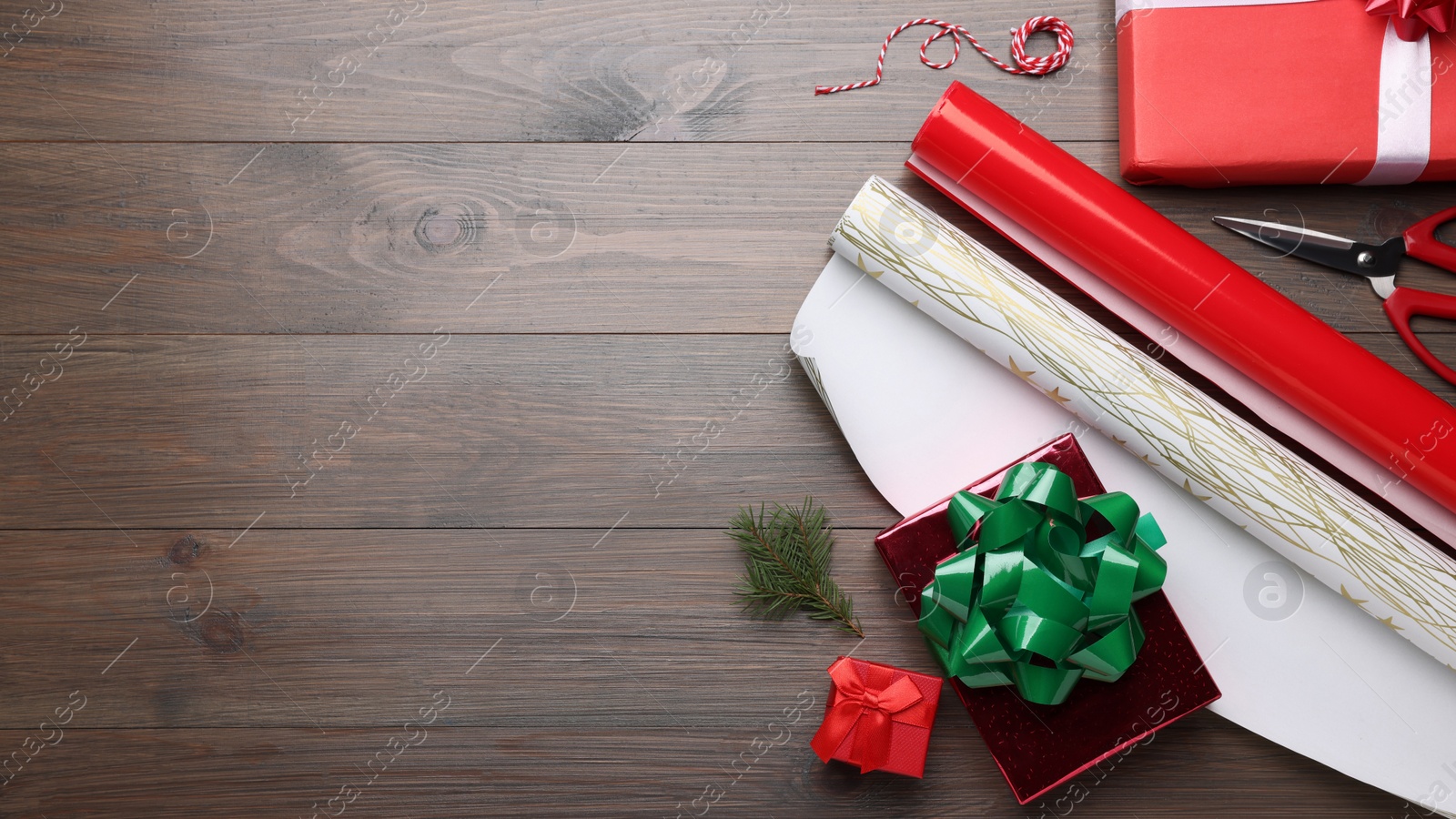 Photo of Flat lay composition with beautifully wrapped gift boxes on wooden table, space for text