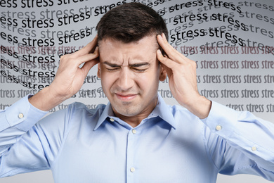 Image of Young man suffering from depression and words STRESS on light background