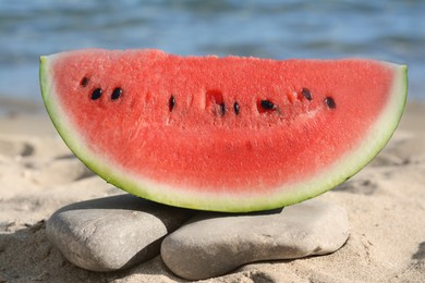 Slice of fresh juicy watermelon near sea, closeup