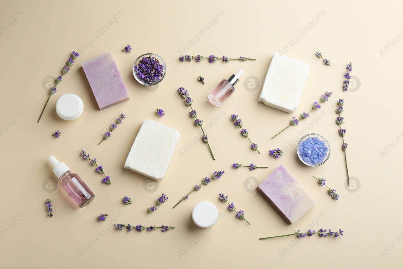 Photo of Flat lay composition of handmade soap bars with lavender flowers and ingredients on beige background