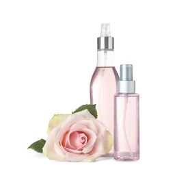 Photo of Bottles of essential oil and rose on white background