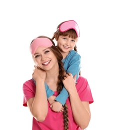 Happy woman and daughter in pajamas on white background