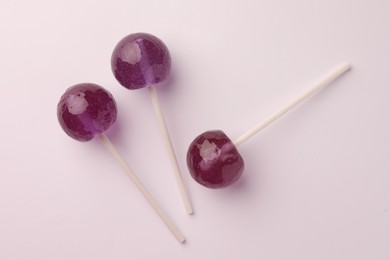 Photo of Tasty lollipops on white background, flat lay