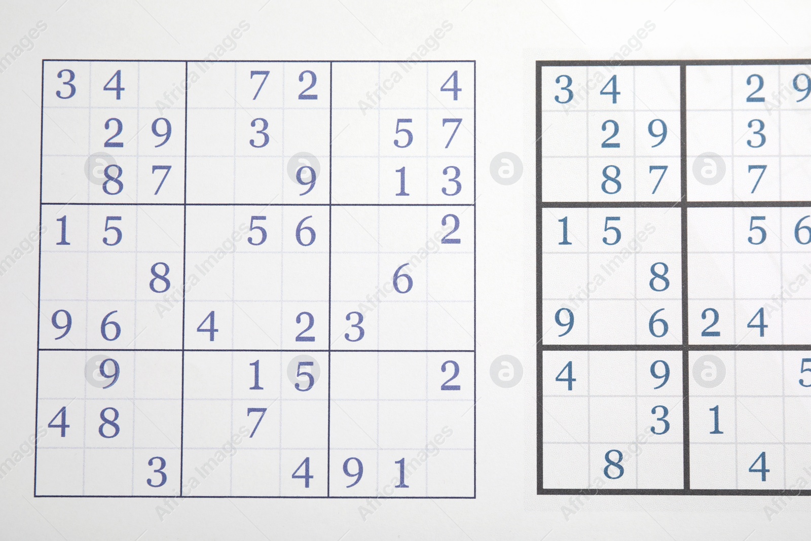 Photo of Sudoku puzzle grids as background, top view