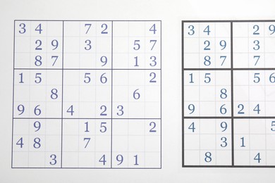 Photo of Sudoku puzzle grids as background, top view