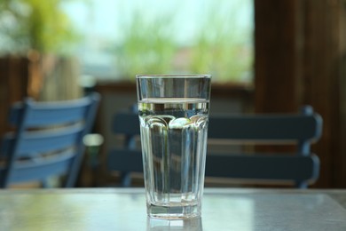 Photo of Glass of fresh water on table indoors