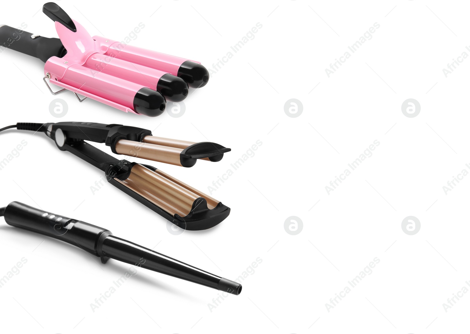 Image of Different hair curling irons on white background