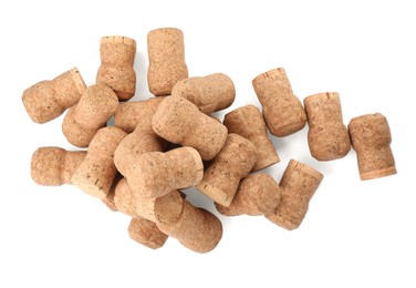 Photo of Heap of sparkling wine corks on white background, top view