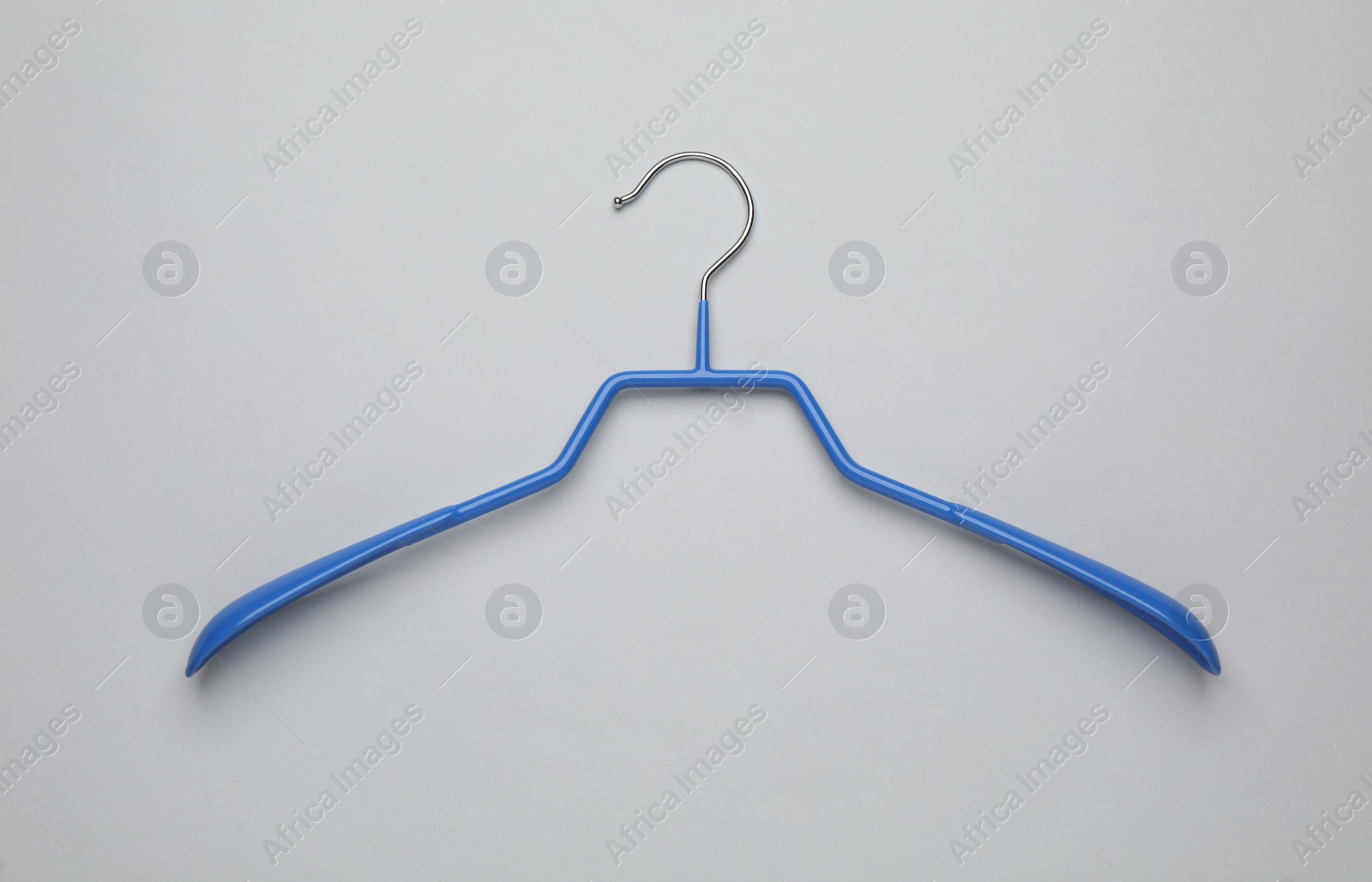 Photo of Empty clothes hanger on white background, top view