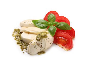 Photo of Tasty salad Caprese with mozzarella, tomatoes, basil and pesto sauce isolated on white
