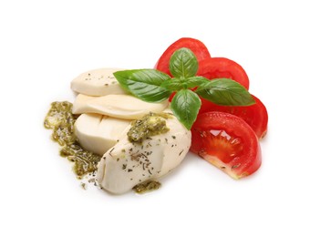 Tasty salad Caprese with mozzarella, tomatoes, basil and pesto sauce isolated on white