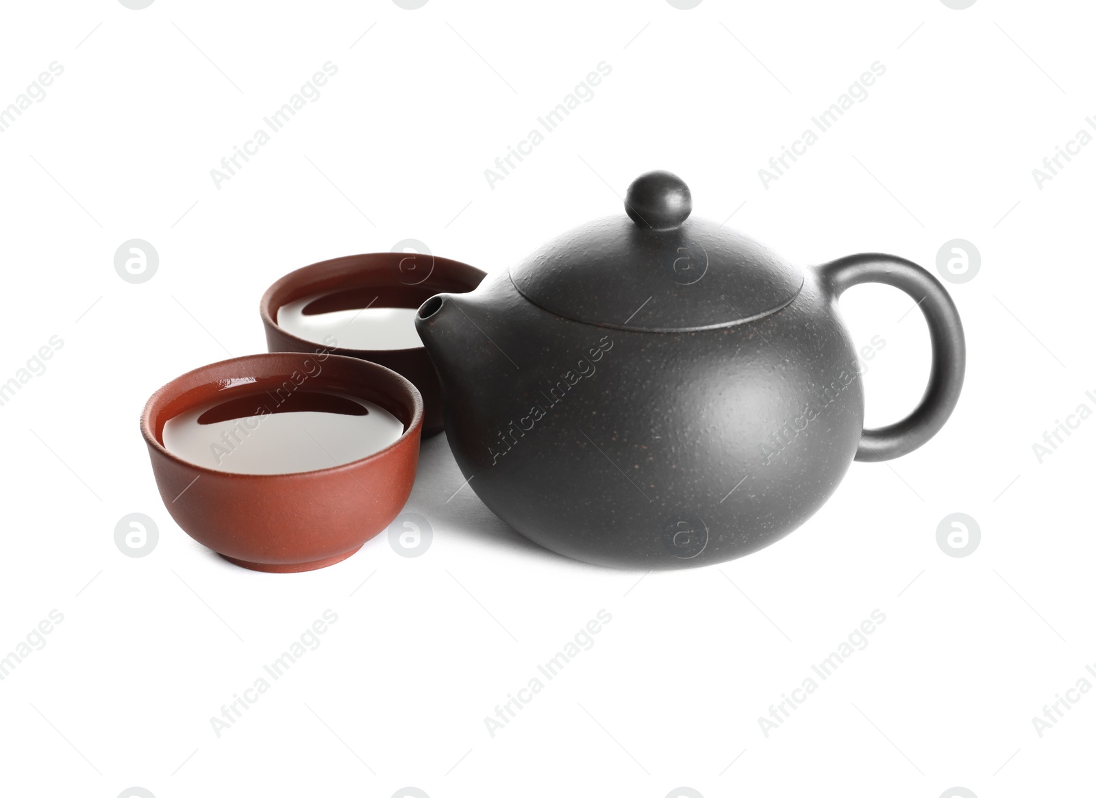 Photo of Cups and teapot of freshly brewed oolong on white background