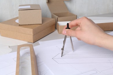 Photo of Man creating packaging design at table, closeup