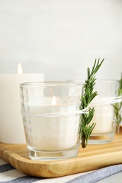 Photo of Wooden tray with burning candles on table. Space for text